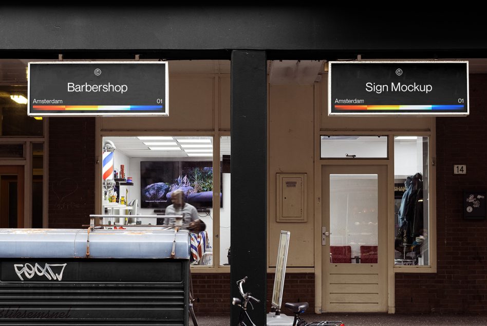 Two dark signs above storefronts with rainbow bar accents on storefront divider