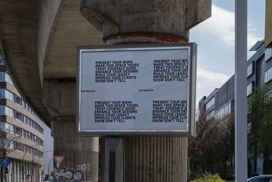 Gray billboard mockup under concrete overpass showing four identical text blocks displayed
