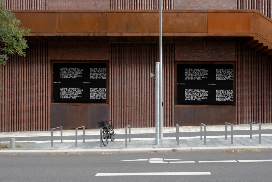 Two storefront windows with dark display panels showing repeated typography layout