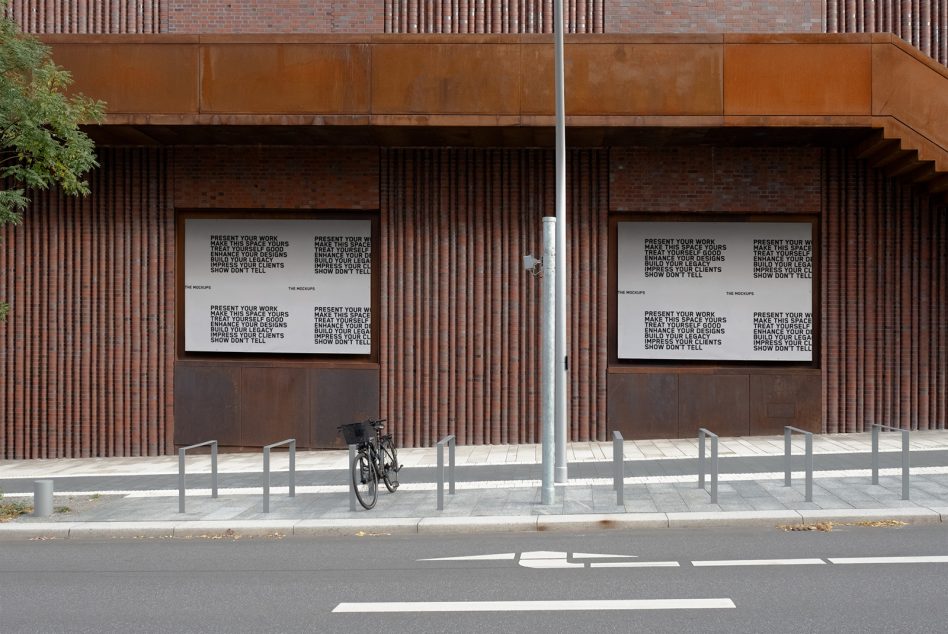 Two storefront windows with light display panels showing repeated typography layout