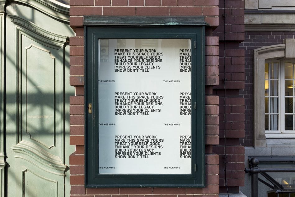 Dark green storefront window case mounted on brick with white background mockup