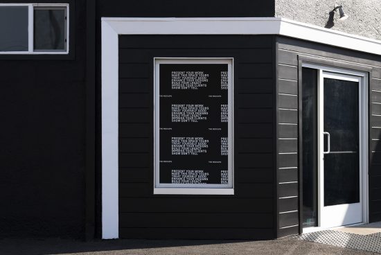Poster mockup on exterior wall for presentation, featuring bold text and modern design set against a building's black facade, ideal for branding.