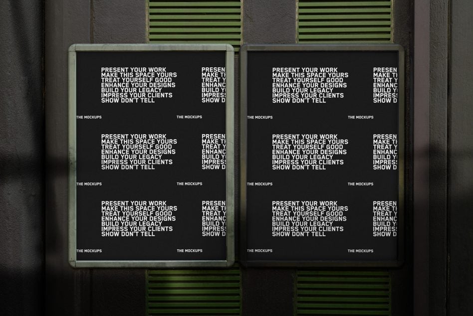 Two black posters in sage frames mounted side by side on dark wall