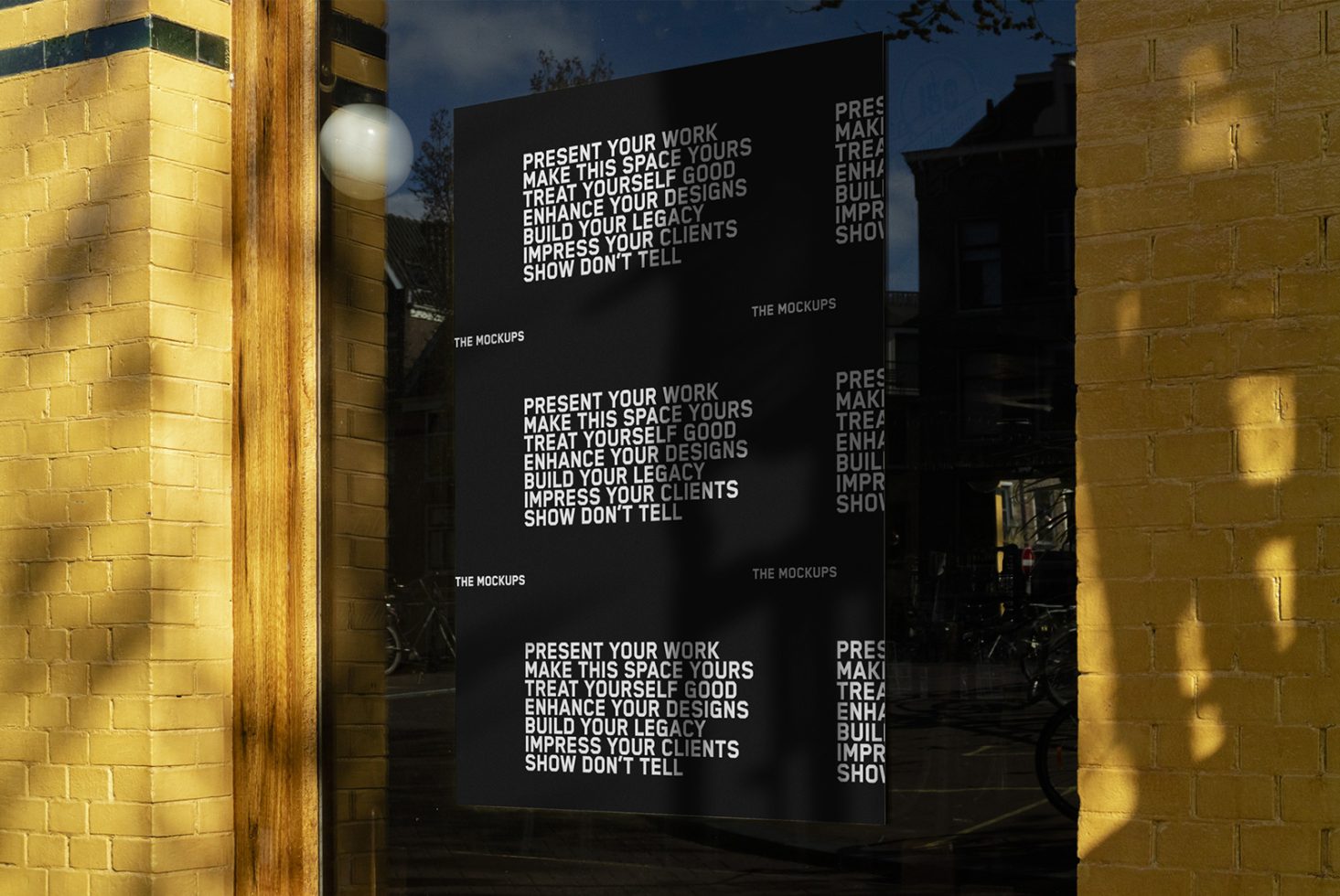 Graphic design poster reflected on window with inspirational phrases, ideal for Mockups category, showcasing text design and lighting effects.