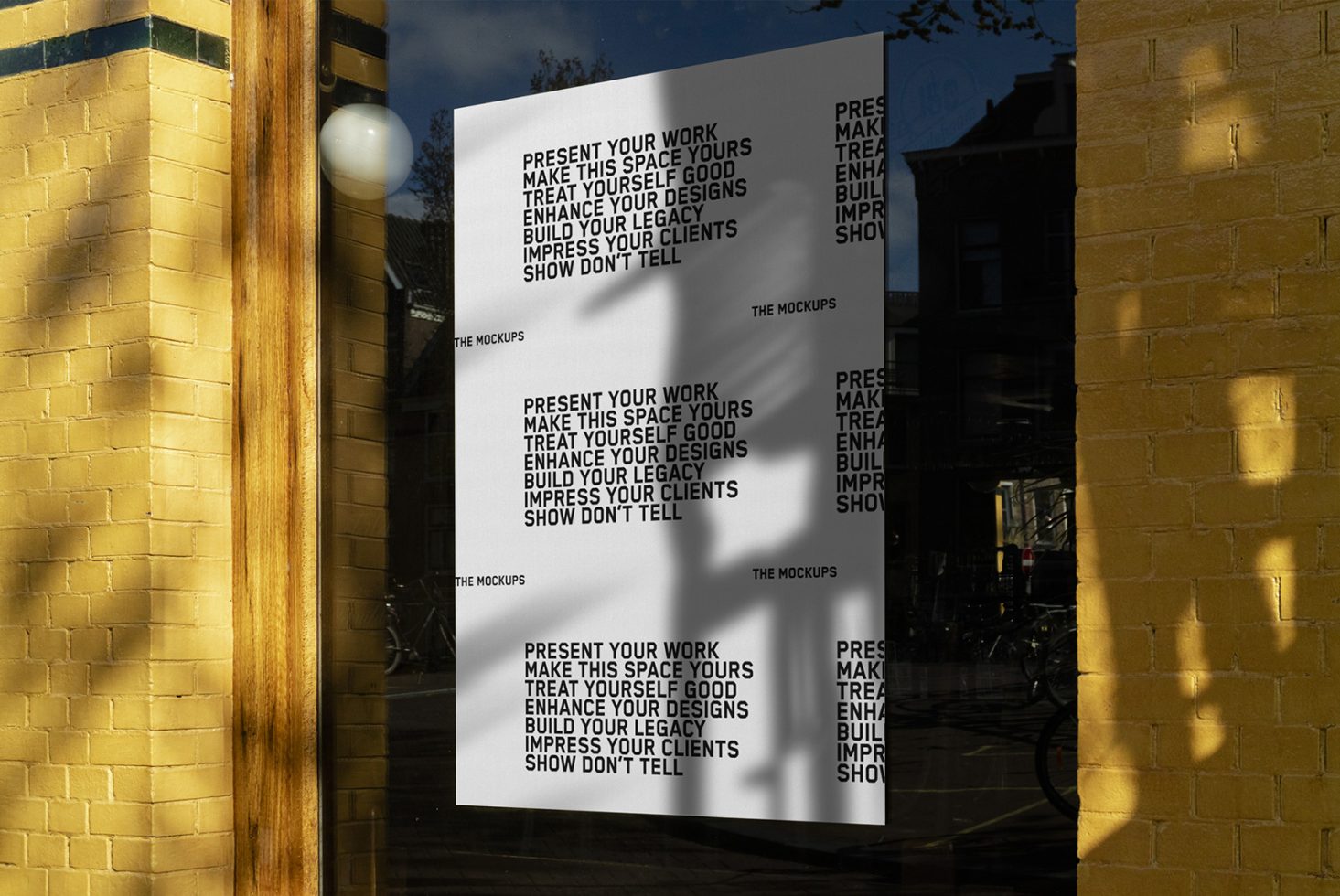 Street poster mockup on a sunny wall with reflections, ideal for presenting design work and graphics in a realistic urban setting.