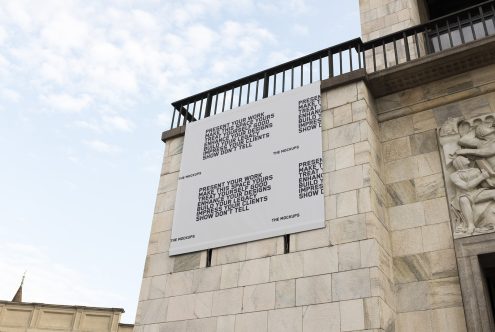 Urban billboard mockup on classic stone building for presenting design work, suitable for designers and creative agencies.