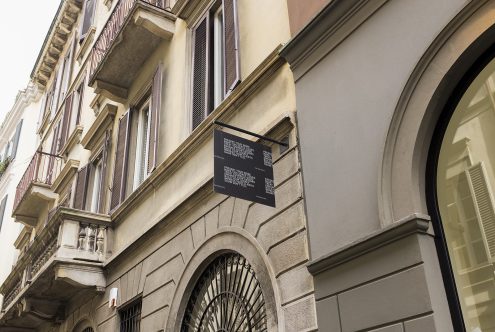 Vintage building facade with hanging sign mockup for storefront branding, classic architecture, urban environment for design templates.