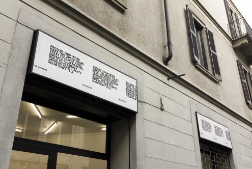 Outdoor mockup of signage above a shop entrance with a sleek design, advertising the utility of mockups in showcasing designers' work.