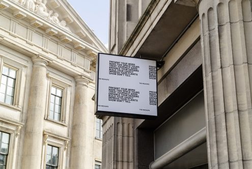 Outdoor billboard mockup in urban setting for showcasing advertising designs, with classical architecture, suitable for graphic presentations.