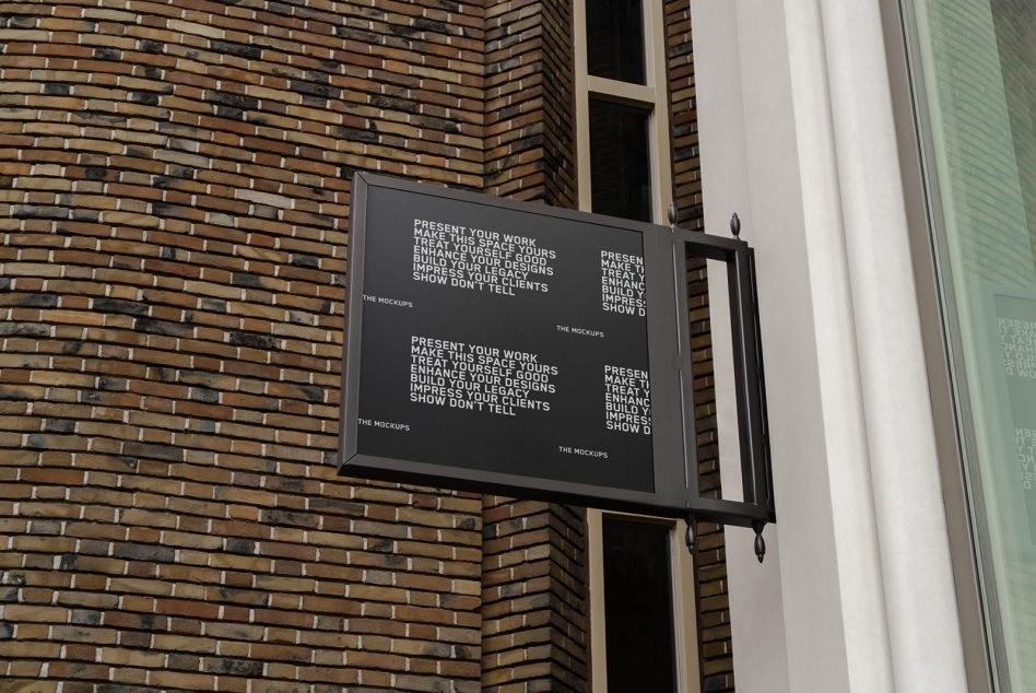 Dark display box mounted on brick exterior with illuminated white text panels