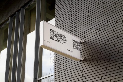 Exterior signage mockup on brick wall showcasing design and typography, ideal for presenting brand identities to clients.