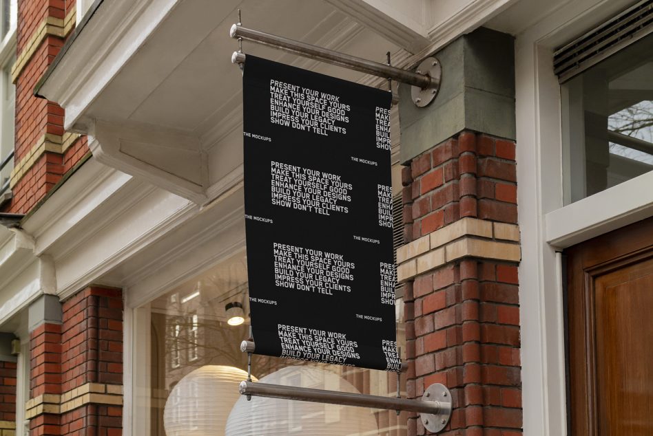 Black fabric banner hanging from metal rod outside brick building entrance