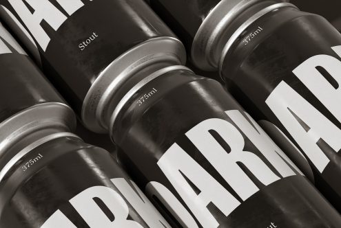 Close-up of black and white beer can mockups with bold font, suitable for product packaging presentations, in a monochrome palette.