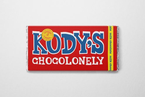 Mockup of a chocolate bar with vibrant red and blue packaging, showcasing bold typography and a quality seal, on a plain background.