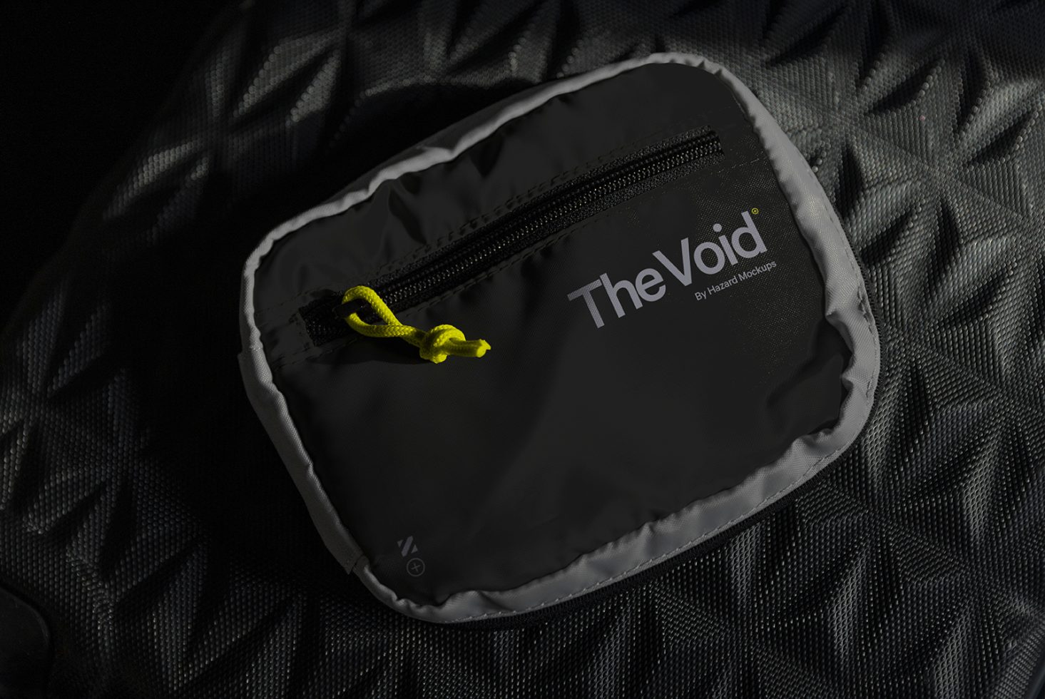 Black zipper pouch mockup with bright yellow pull tab on textured background, showcasing logo design, ideal for branding presentation.