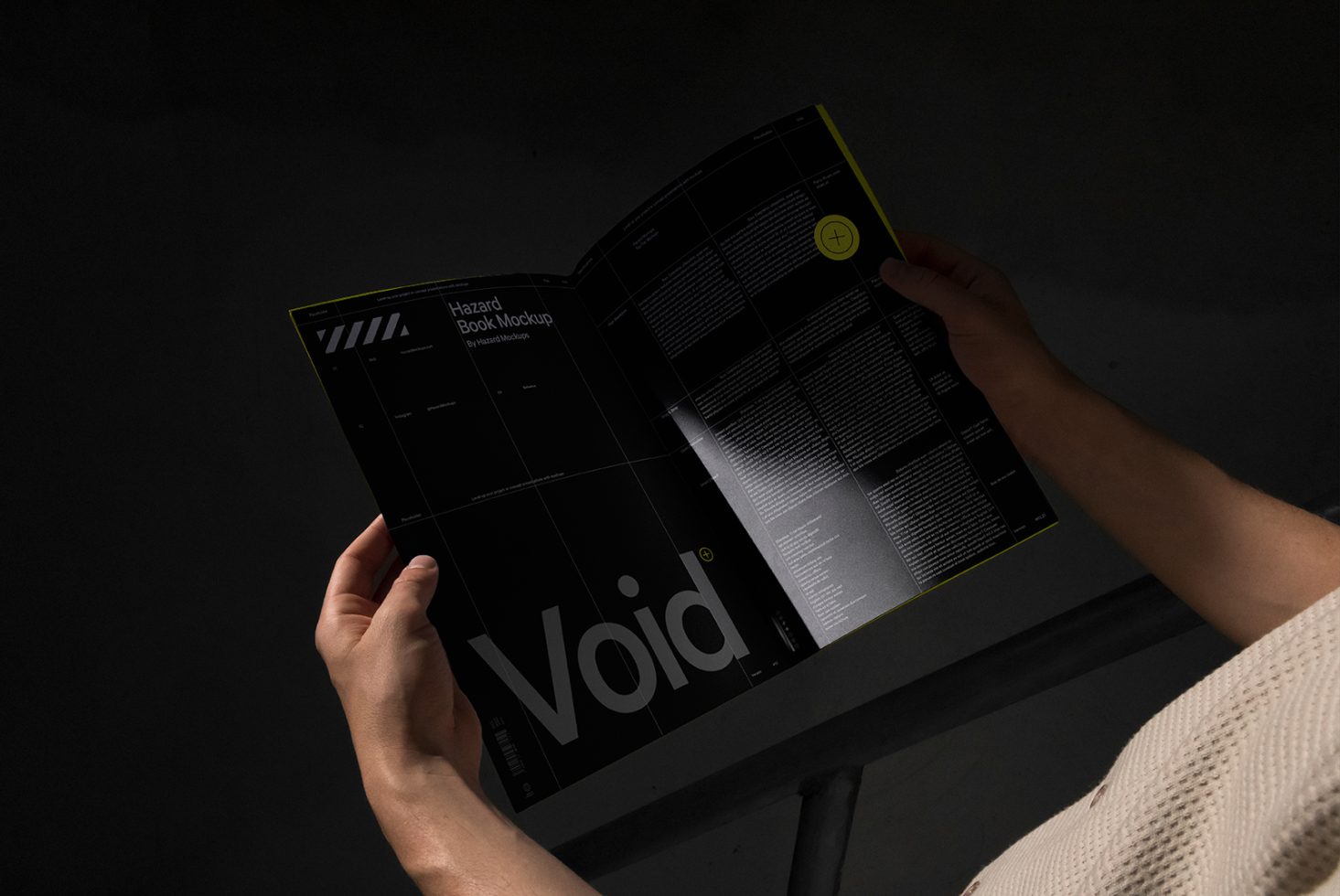 Hand holding open magazine mockup with modern design layout, showcasing bold fonts and graphics in a dark setting for creative portfolio display.