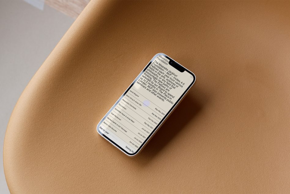 iPhone on tan surface displaying scrollable list with light purple highlight on row