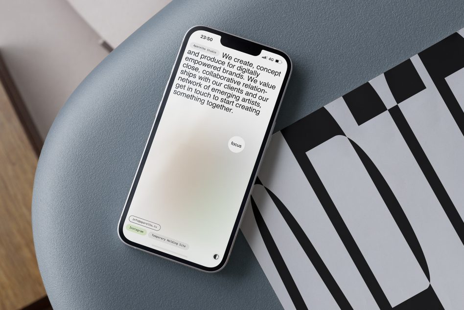 iPhone on blue surface showing light app screen with body text over striped graphic