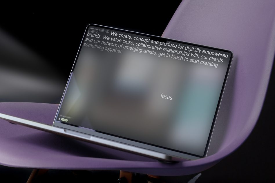 Laptop mockup on purple curved surface showing website with blurred content text