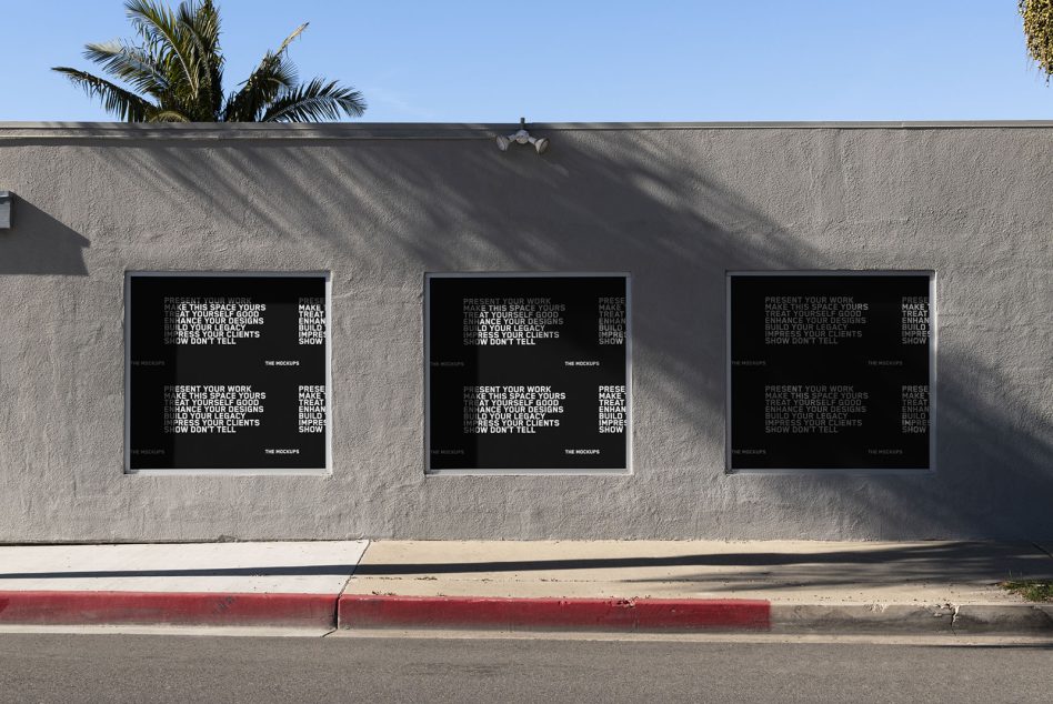 Three horizontal window displays with black poster mockups on concrete wall