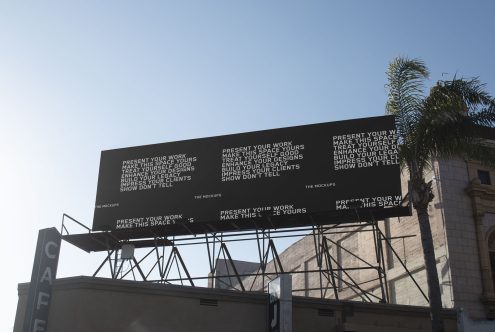 Billboard mockup on blue sky with palm tree, ideal for showcasing advertisements, designs or branding for designers.