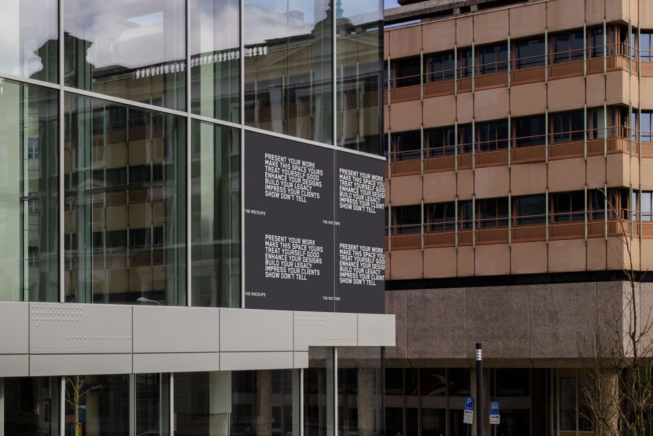 Dark billboard on modern building facade with white text layout showing multiple repeated message blocks