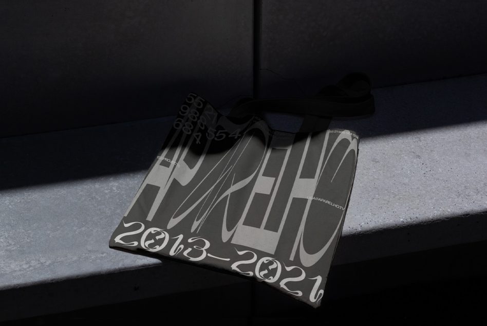 Magazine mockup leaning against concrete wall with dramatic shadow, dates 2023-2024 visible