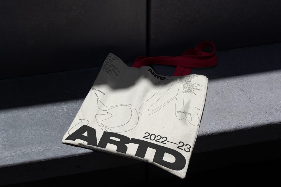 Open magazine mockup with minimalist line art, bold typography, red ribbon bookmark on dark concrete background