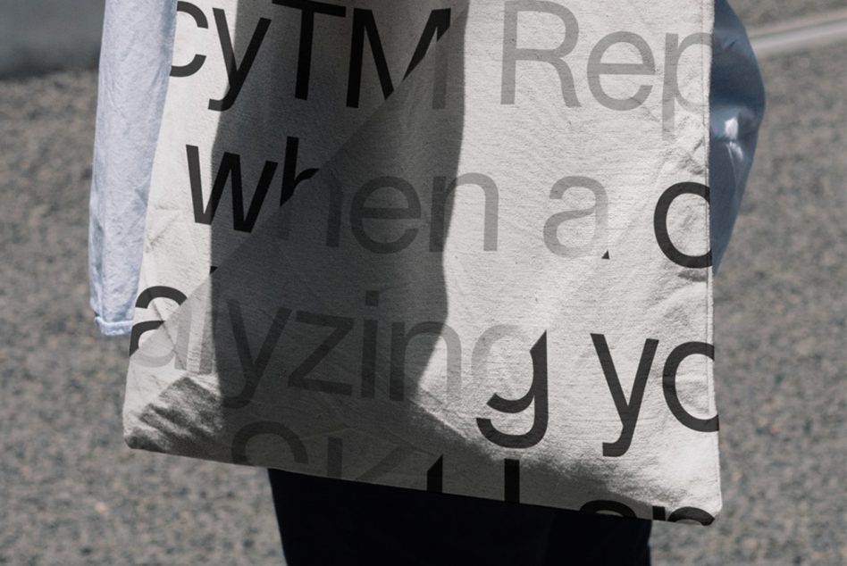 Close up of canvas tote showing large sans serif text with shadow effect