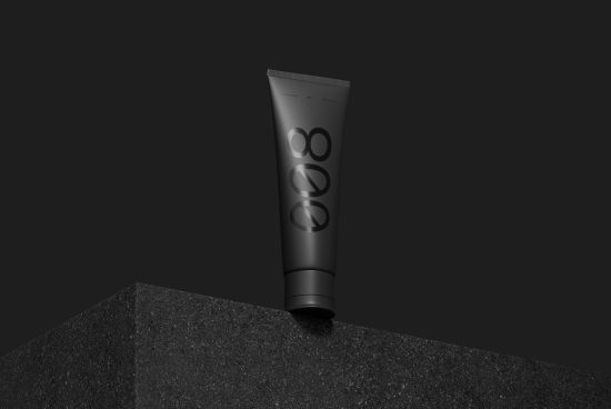 Black tube packaging mockup with minimalist branding on dark background, ideal for cosmetic product design presentations.
