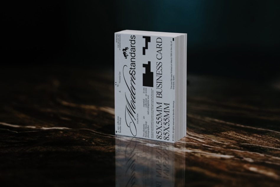 Business card mockup book standing on dark wood with teal backdrop