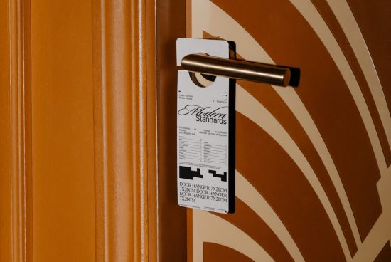 Door hanger mockup on a brown hotel door with a minimalist design, providing a template for designers to showcase branding or signage.