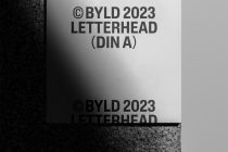 White DIN A letterhead mockup showing centered black text layout