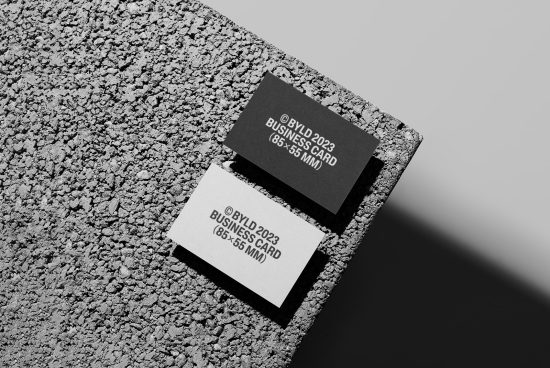 Business card mockup on textured background, modern design, 85x55mm, black and white cards, top view, branding presentation, realistic shadows.