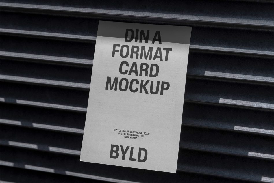 White DIN A format card mockup tilted on dark ribbed metal backdrop
