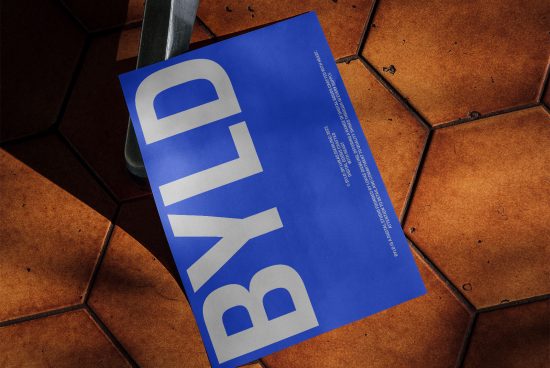 Modern Poster Mockup Design with bold typography on a blue background, displayed on an urban tile floor for graphic designers.