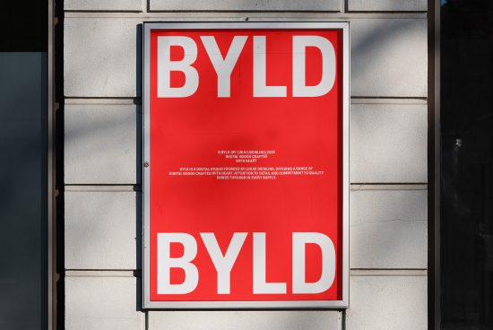 Bold red poster mockup with white typography design for BYLD, showcased in an urban setting, perfect for display and branding projects.
