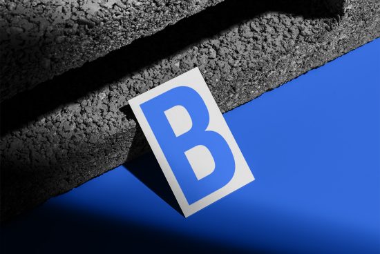 Blue letter B on white card mockup with textured shadow, graphic design, creative presentation, branding display, minimalist backdrop.