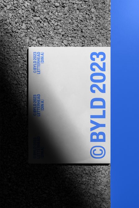 Letterhead design mockup with blue text on concrete texture, showcasing contemporary design layout for print and graphic resources.