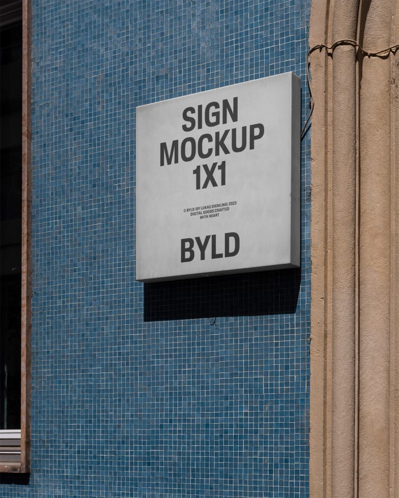 Wall-mounted square sign mockup on a blue tiled building facade next to a beige curtain, clear sky, ideal for branding presentations, design assets.