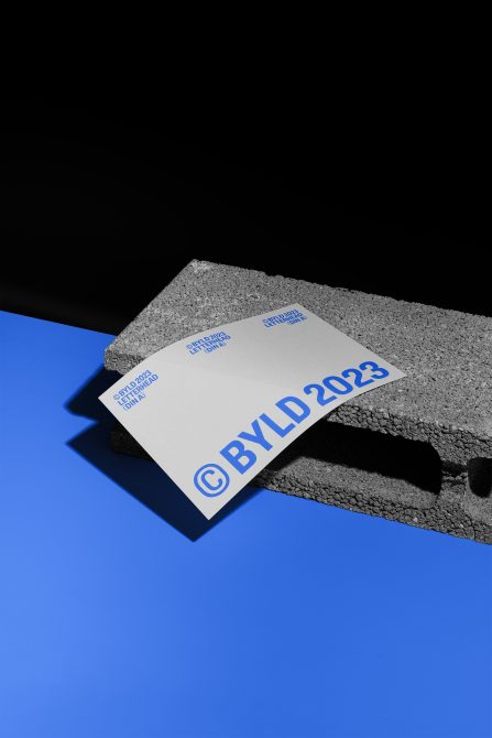 Business card mockup on textured surface with dynamic shadow, creative presentation for branding, print design showcase.