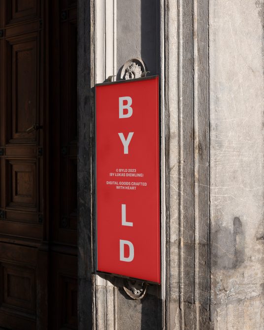 Red vertical shop sign mockup on historic building with bold typography, ideal for branding presentations, storefront and signage designs.