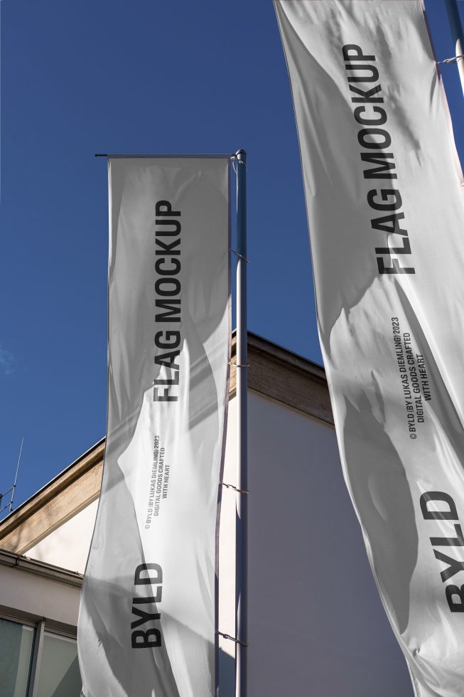 Vertical flag mockup templates fluttering against a clear blue sky, showcasing editable design space for branding and advertising.