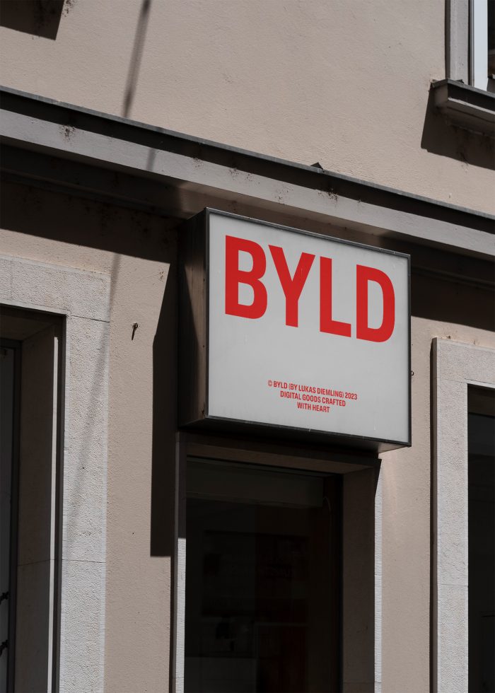 Red and white storefront sign reading BYLD, ideal for mockup display in urban setting for advertising and brand design.