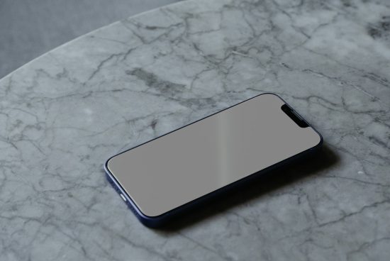 Smartphone mockup on marble surface, ideal for showcasing app designs and responsive websites, high resolution, professional look, digital asset.