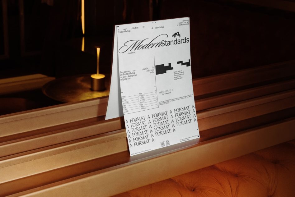 Modern Standards poster mockup standing on wooden bench under gold lamp
