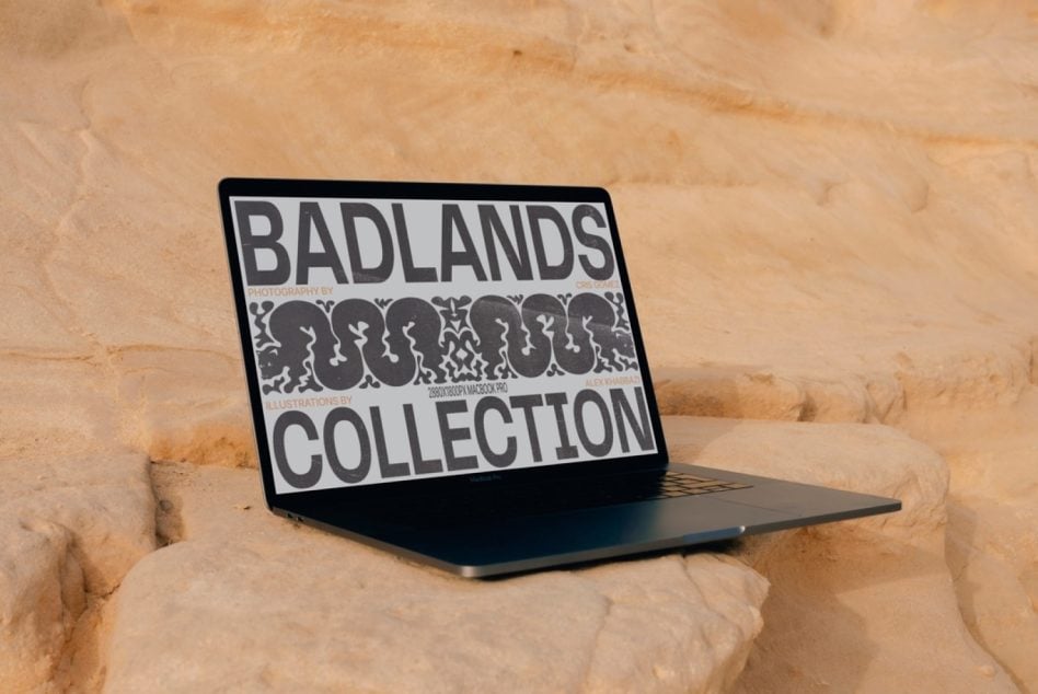 Laptop screen displaying black design mockup on textured stone wall