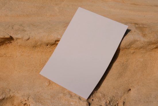 Blank A4 paper mockup on a natural sandstone texture for presentation of designs and graphics, ideal for showcasing stationery or flyers.