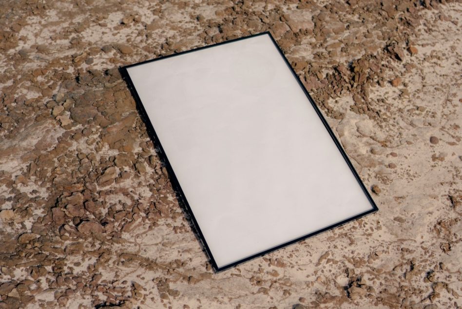 Blank poster mockup angled on rough stone terrain
