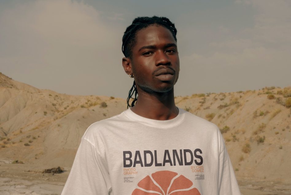 Badlands tee with floral design on model staring straight ahead outdoors